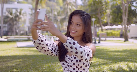 Image showing Smiling Asian woman taking selfie on smartphone with smile