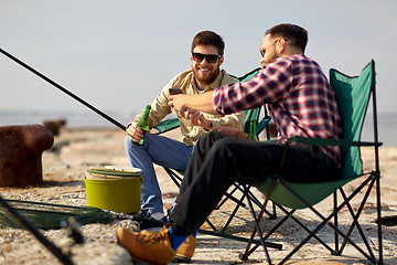 Image showing friends with smartphone and beer fishing on pier