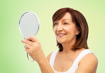 Image showing portrait of smiling senior woman with mirror