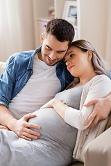 Image showing man hugging pregnant woman at home