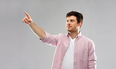 Image showing young man showing something