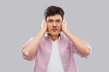 Image showing man closing ears by hands