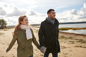 Image showing couple walking along autumn beach