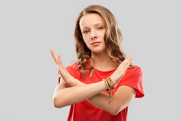 Image showing teenage girl crossing hands in forbidding gesture