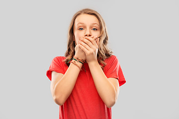 Image showing shocked teenage girl covering her mouth by hands