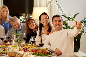 Image showing family having dinner party and taking selfie