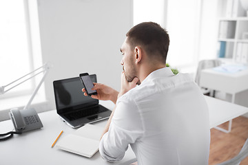 Image showing businessman using smartphone at office