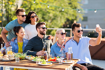 Image showing happy friends taking selfie at rooftop party