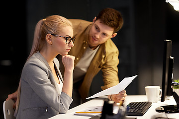 Image showing business team with papers working at night office