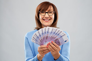 Image showing senior woman holding hundred euro money banknotes