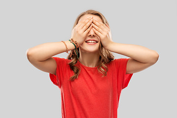 Image showing smiling teenage girl in red t-shirt over grey