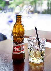 Image showing Bottle and glass of swiss popular lemonade Rivella