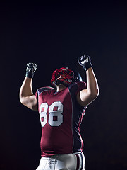 Image showing american football player celebrating after scoring a touchdown