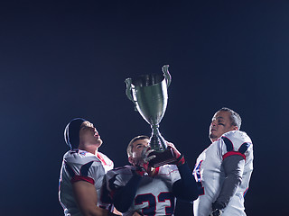 Image showing american football team with trophy celebrating victory