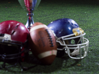 Image showing closeup of american football,helmets and trophy