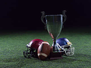 Image showing closeup of american football,helmets and trophy