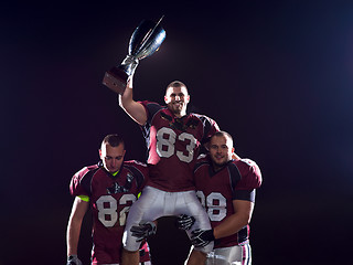 Image showing american football team with trophy celebrating victory