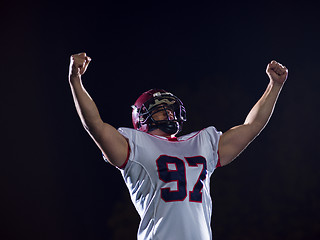 Image showing american football player celebrating after scoring a touchdown