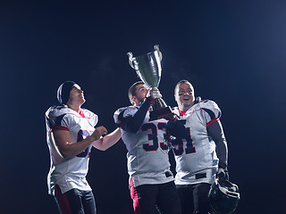 Image showing american football team with trophy celebrating victory