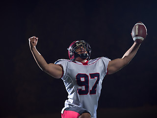 Image showing american football player celebrating after scoring a touchdown