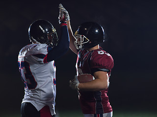 Image showing american football players celebrating after scoring a touchdown