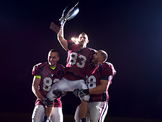 Image showing american football team with trophy celebrating victory