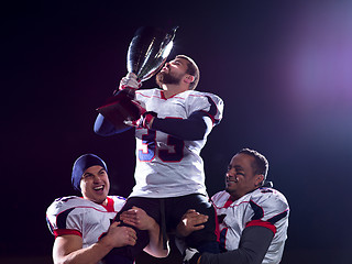 Image showing american football team with trophy celebrating victory