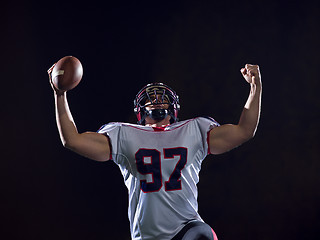 Image showing american football player celebrating after scoring a touchdown