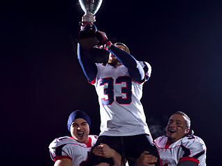 Image showing american football team with trophy celebrating victory