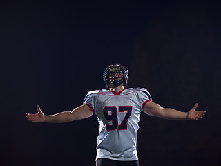 Image showing american football player celebrating after scoring a touchdown