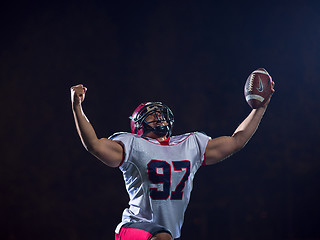 Image showing american football player celebrating after scoring a touchdown