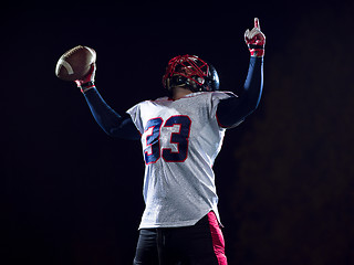 Image showing american football player celebrating after scoring a touchdown