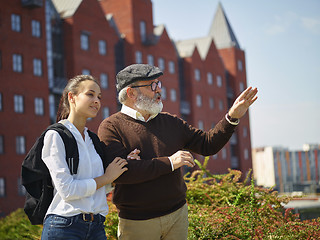 Image showing Portrait of young girl embracing grandfather at park