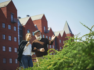 Image showing Portrait of young girl embracing grandfather at park