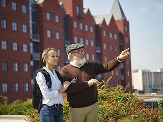 Image showing Portrait of young girl embracing grandfather at park