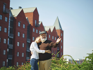 Image showing Portrait of young girl embracing grandfather at park