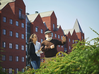 Image showing Portrait of young girl embracing grandfather at park