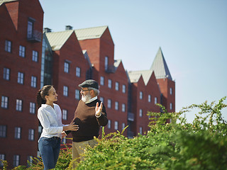 Image showing Portrait of young girl embracing grandfather at park