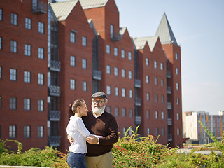 Image showing Portrait of young girl embracing grandfather at park