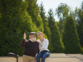 Image showing Portrait of young girl embracing grandfather at park