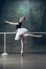 Image showing The classic ballerina posing at ballet barre