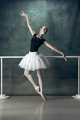 Image showing The classic ballerina posing at ballet barre