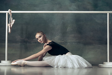 Image showing The classic ballerina posing at ballet barre