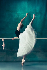 Image showing The classic ballerina posing at ballet barre