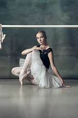 Image showing The classic ballerina posing at ballet barre