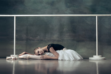 Image showing The classic ballerina posing at ballet barre