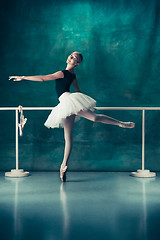 Image showing The classic ballerina posing at ballet barre