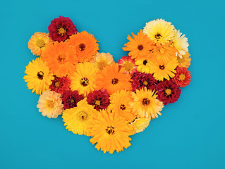 Image showing Yellow calendulas and red dahlias in a flower heart