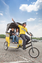 Image showing man driving in bicycle taxi