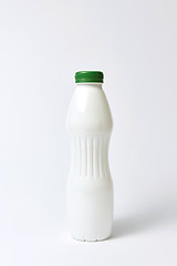 Image showing White plastic bottle mock up for yogurt on a light background.